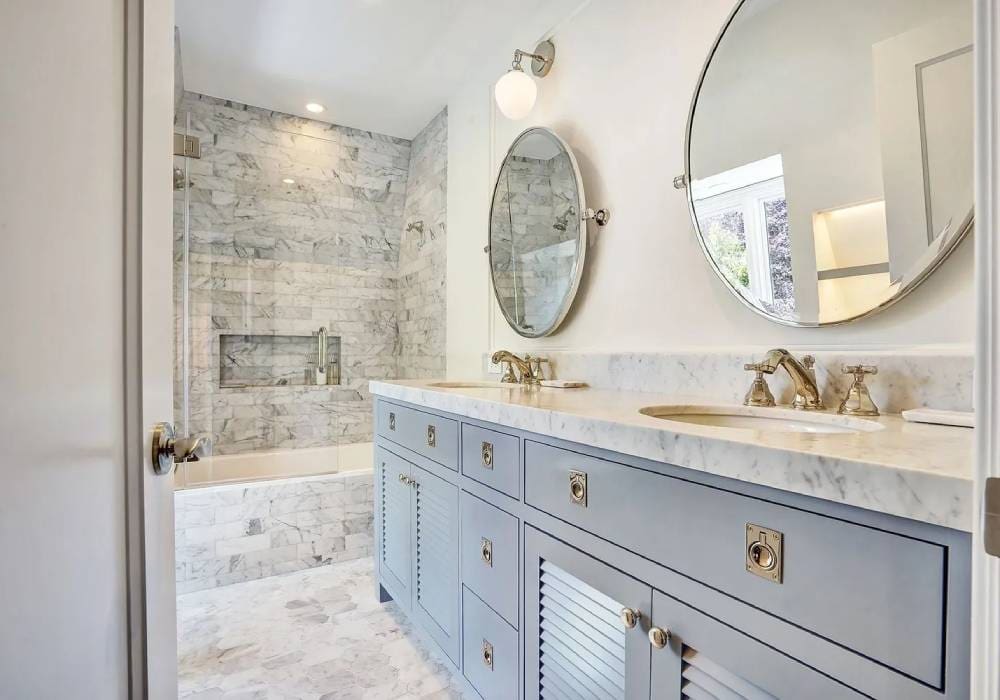 A bathroom with marble floors and walls.