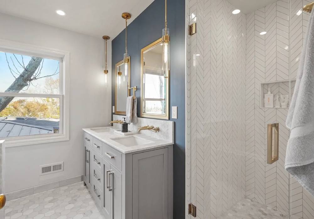 A bathroom with two sinks and a large mirror.