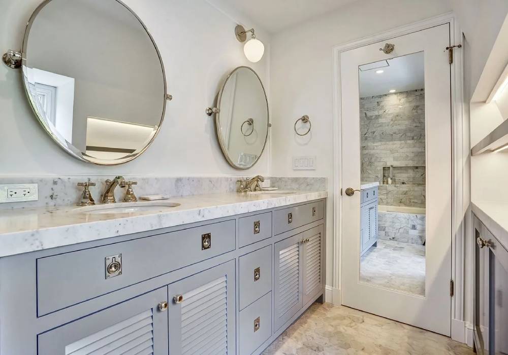 A bathroom with two sinks and a mirror.