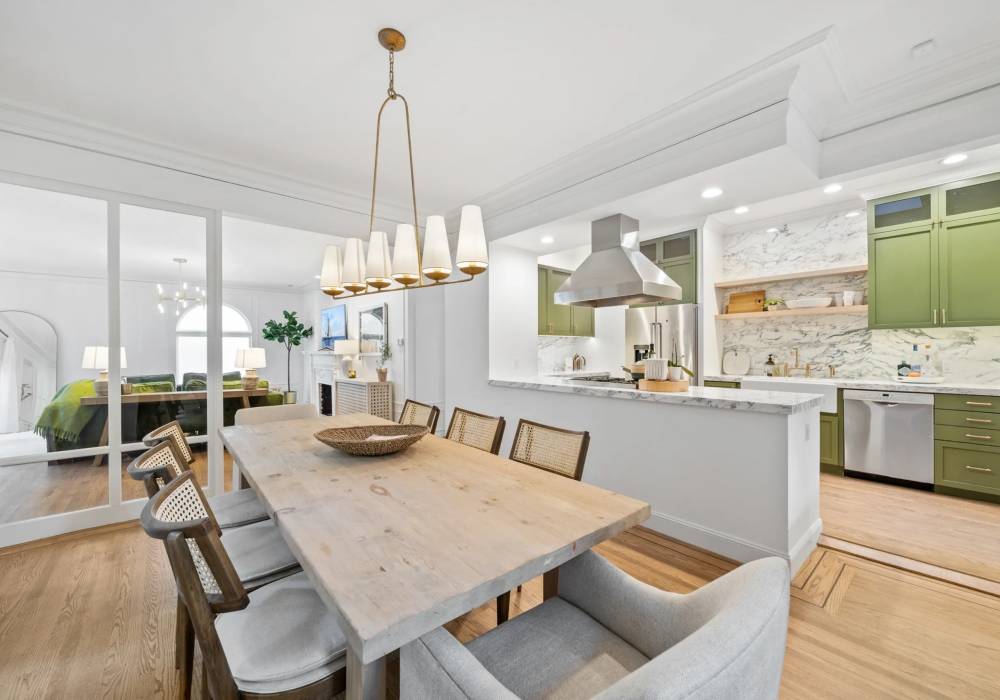 A large dining room table with chairs around it.