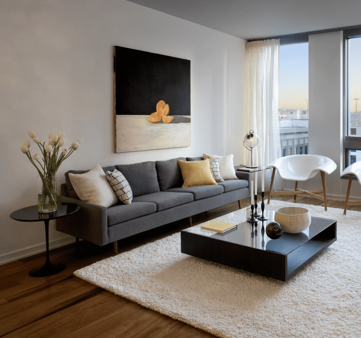 A living room with a couch, table and chair.