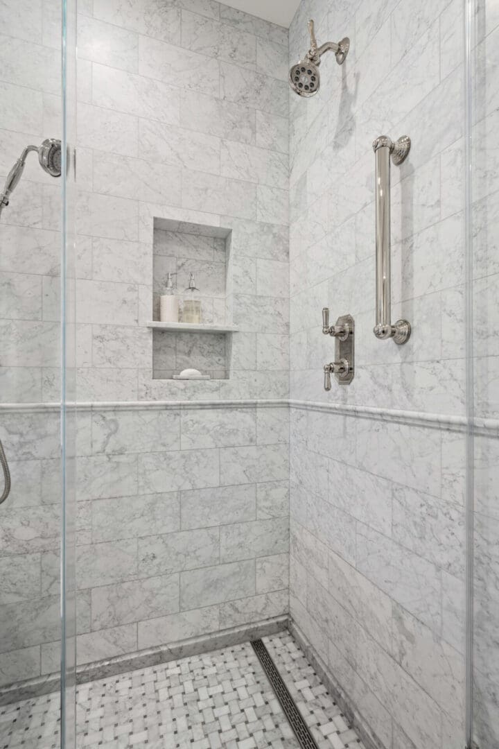 A bathroom with marble walls and floors.