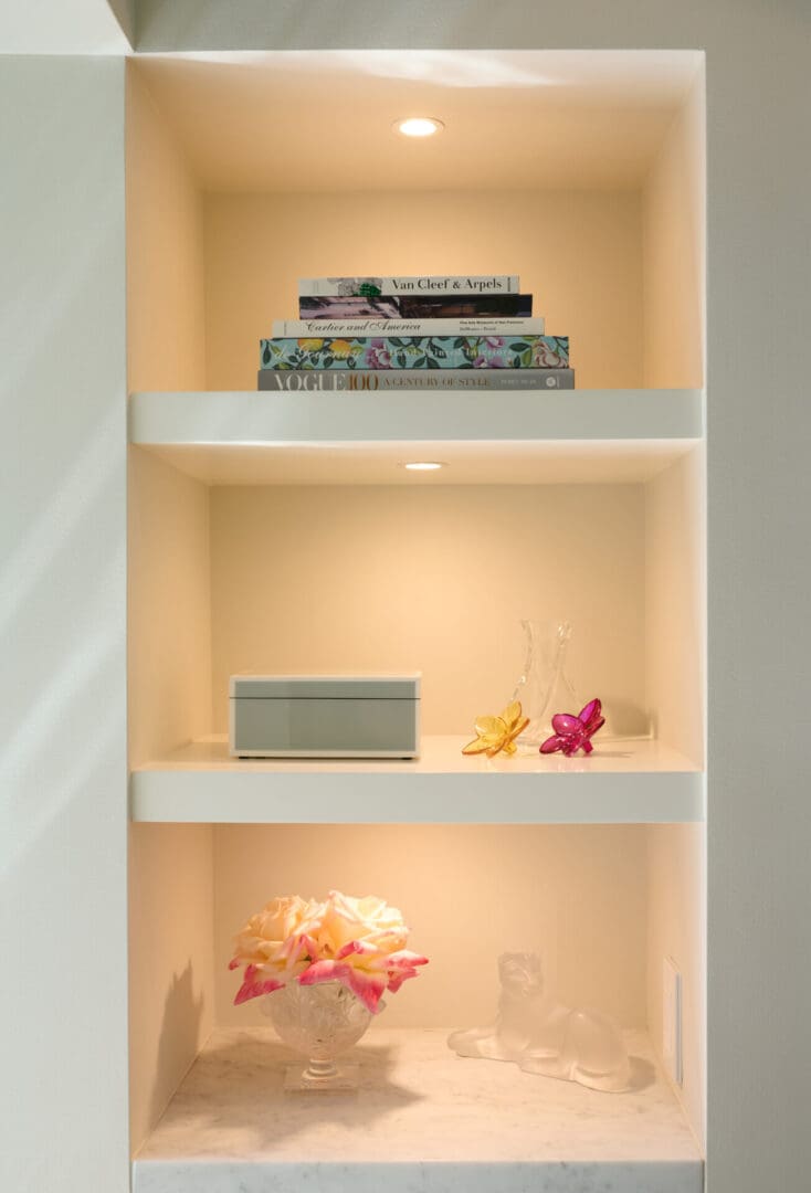 A bookshelf with lights and decorations on it