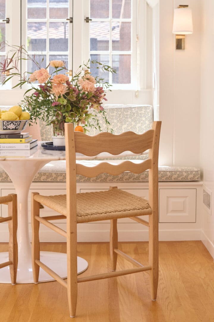 A wooden chair sitting in front of a window.