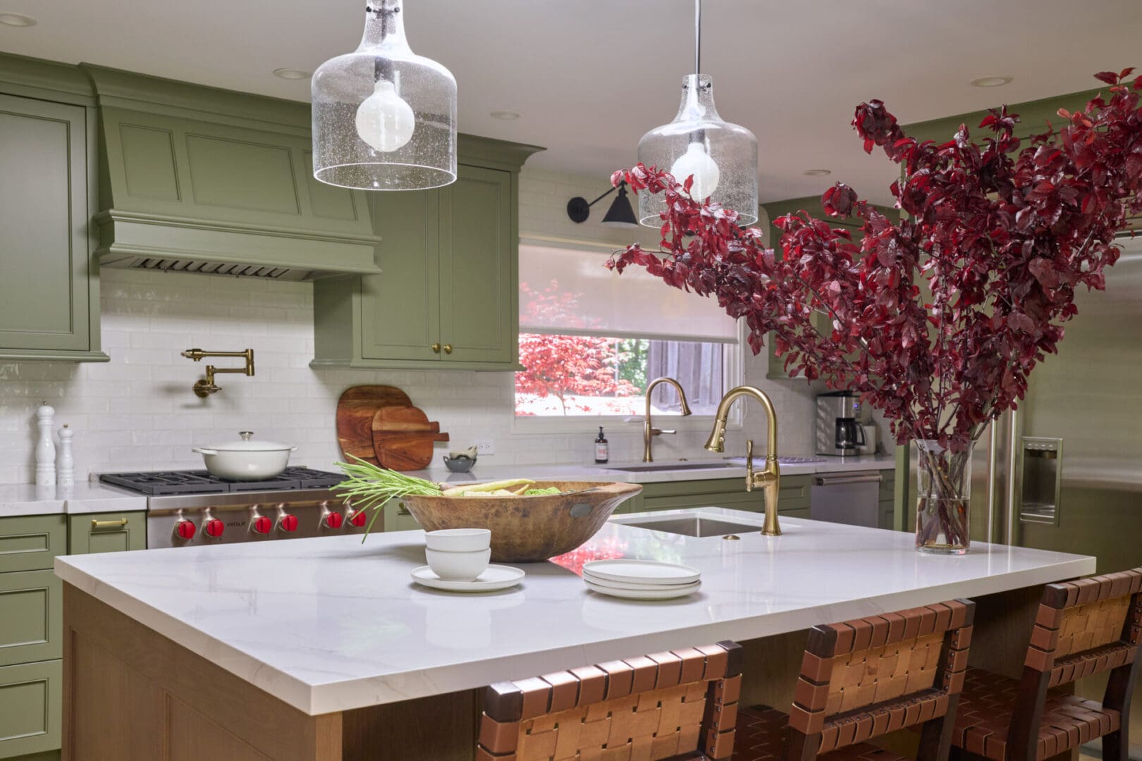 A kitchen with green walls and white counters.