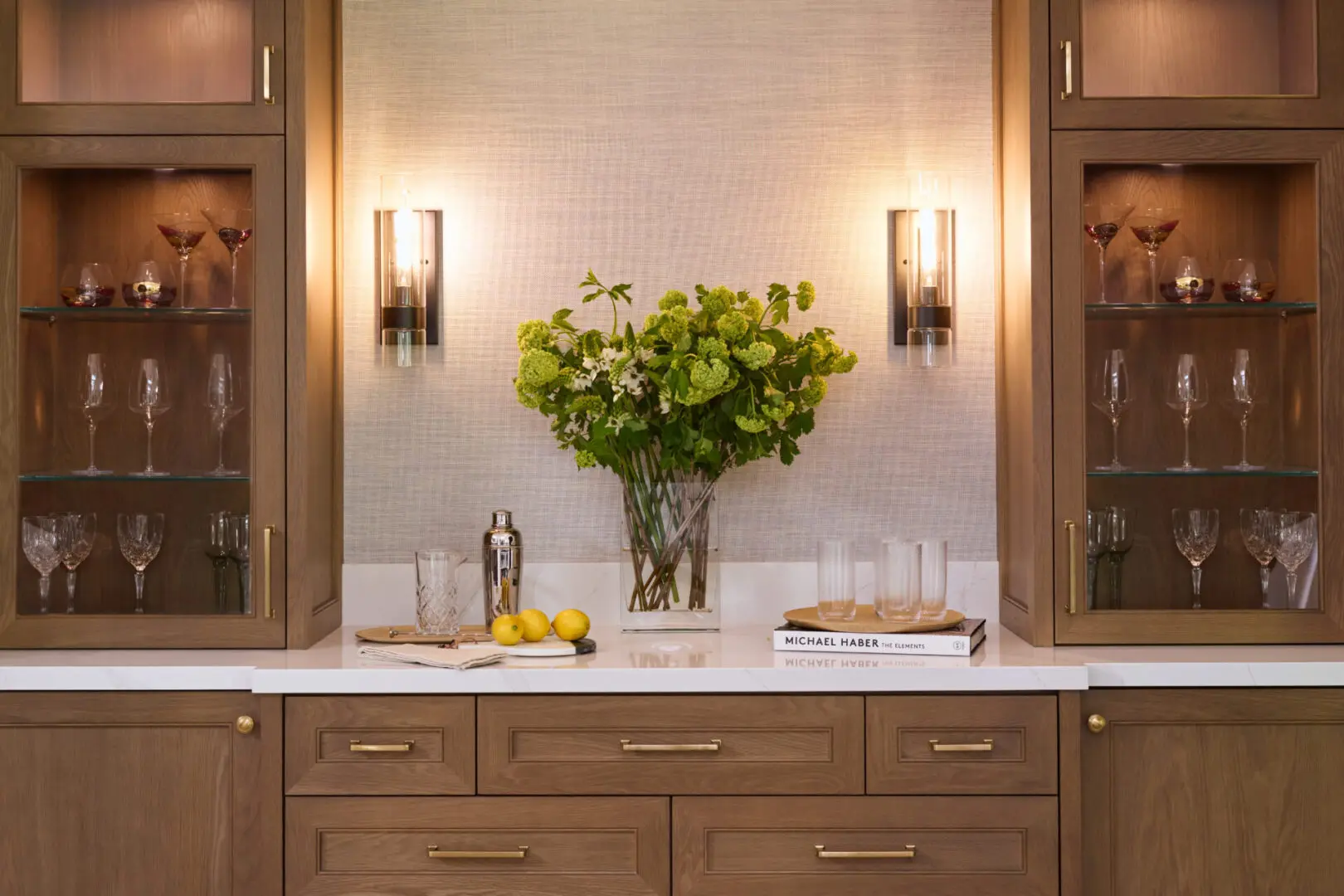 A vase of flowers on the counter in a kitchen.