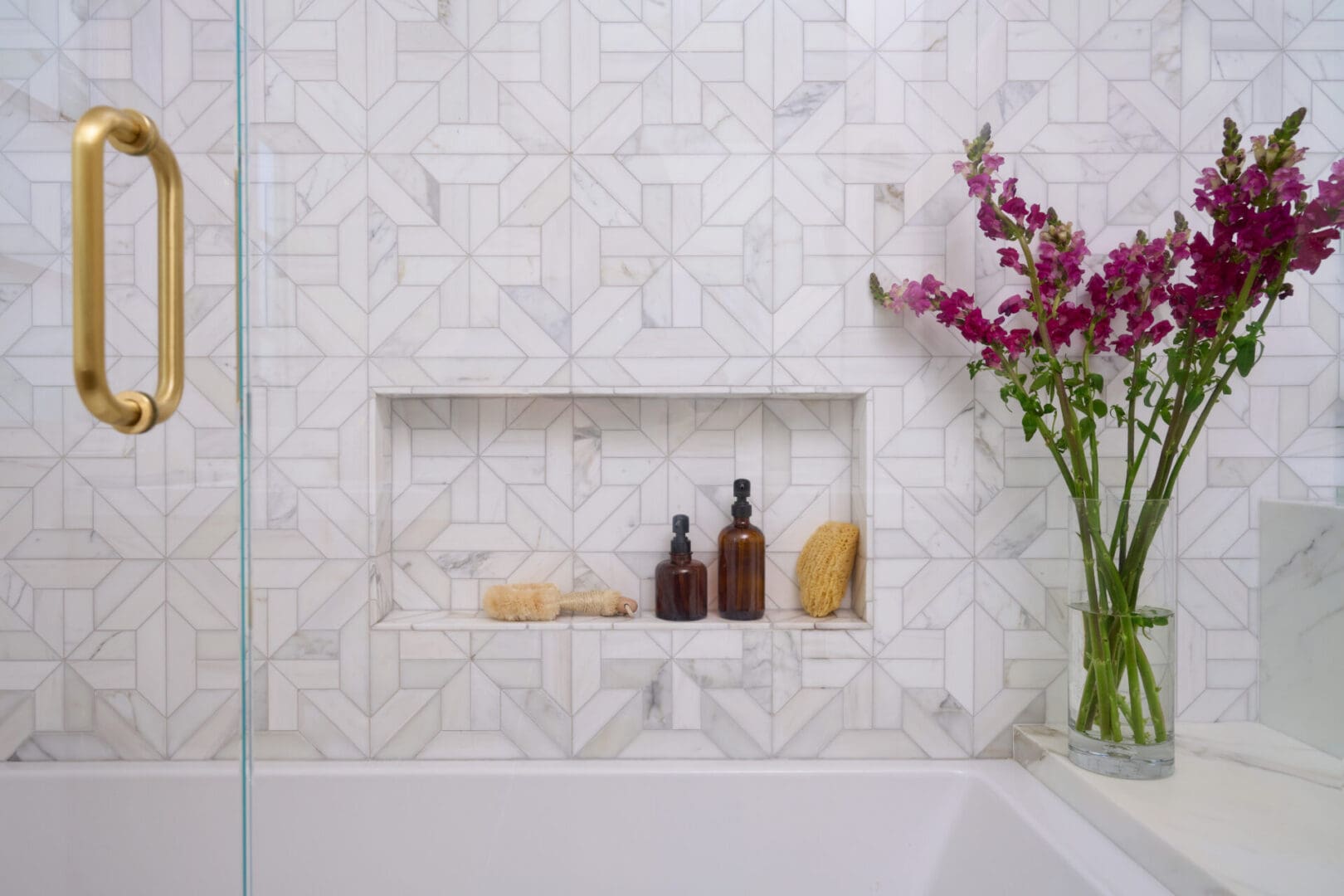 A bathroom with a tub, shower and flowers.