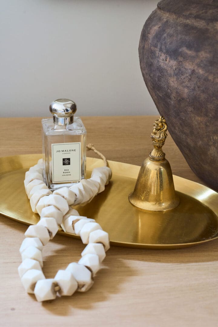 A close up of a bottle and bell on a tray