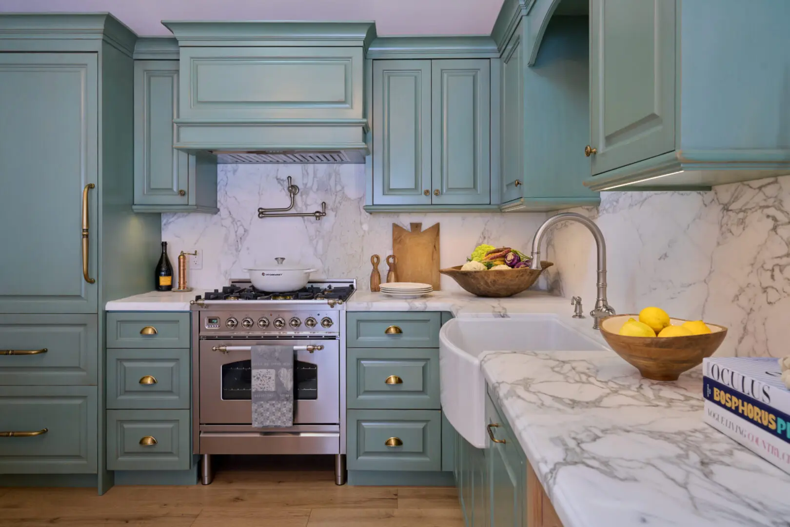 A kitchen with blue cabinets and white countertops.