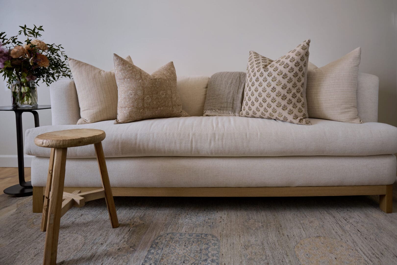 A couch with pillows on it in front of a wall.